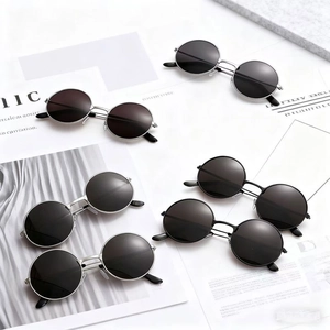 Classic round metal sunglasses in vintage silver and black frames with dark lenses