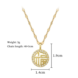 Close-up of gold Fu character necklace with micro-pave crystals and measurements