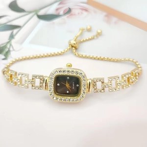 Detail of adjustable gold-tone square watch with crystals and floral background