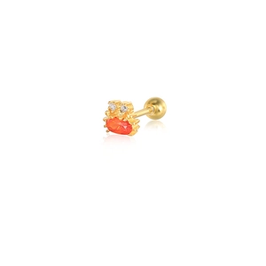 Detailed view of a gold crab cartilage stud earring with a vibrant red oval gemstone