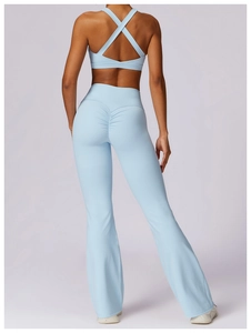 Detail view of light blue yoga set with cross-back sports bra and ruched leggings