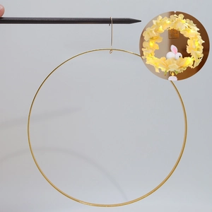 Golden metal wreath ring for DIY floral crafts with a rabbit lamp decorative example