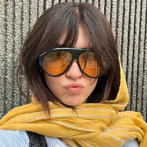 Fashionable oversized aviator sunglasses with orange transparent lenses and black frame