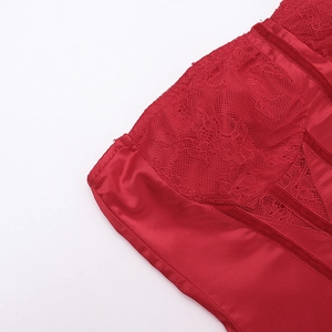 Detail of red lace stitching and glossy satin fabric texture on a backless dress