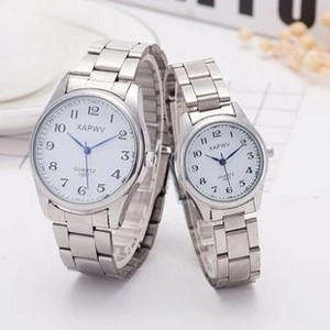 Detail view of silver quartz watches with large numerals and elastic stainless steel bands