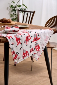 Close-up of Santa Claus print table runner and napkins set on a festive wooden table