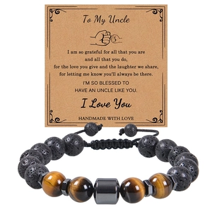 Macro detail of 10mm lava and tiger eye stone bead bracelet for uncle with greeting card
