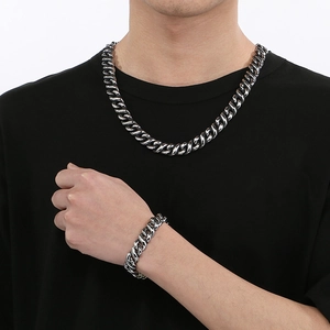 Hip-hop style silver-black Cuban chain necklace and bracelet set for men on model
