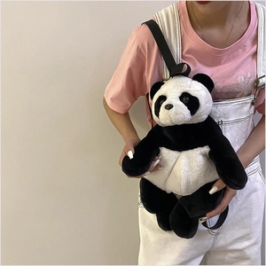 Detail view of a cute plush panda backpack featuring soft faux fur and black shoulder straps