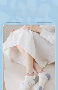 Detail of floral ankle socks with blue yellow flowers and ruffle trim lace edges