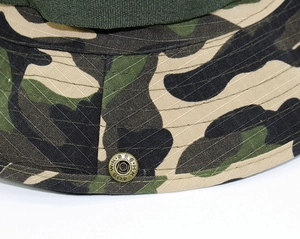 Macro shot of jungle camouflage boonie hat showing parallel stitching and metal buckle