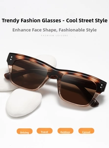 Detail view of retro tortoise shell sunglasses with silver rivets on white pebbles