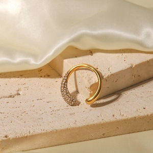Detail of gold-plated open ring featuring a sparkling pavé diamond setting on stone