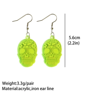 Detail showing fluorescent green skull acrylic earrings with weight and size measurements