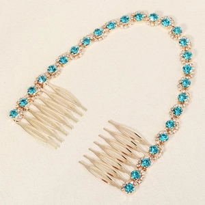 Detailed view of bridal hair combs with gold chain, blue crystals and clear rhinestones