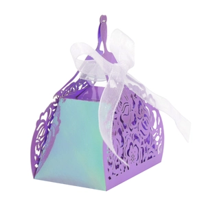 Macro shot of purple laser-cut candy box with iridescent finish and white silk ribbon