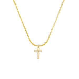 Macro detail of gold snake chain necklace featuring a crystal-studded letter T pendant