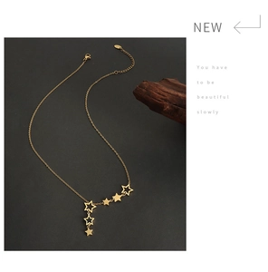Detail of star pendants on a gold plated chain necklace with a lobster clasp closure