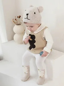 Class A baby winter set with warm bear ear knit hat and matching vest in soft cream tones