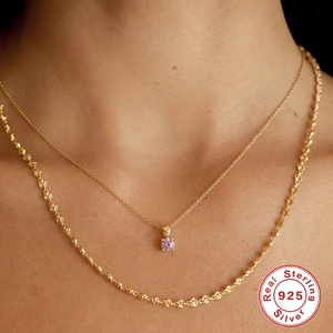 S925 sterling silver gold layered necklace with pink gemstone pendant on female model neck