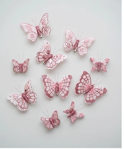 Detailed view of pink feather butterfly hair clips with sequins and pearls in 10-piece set