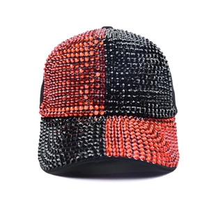 Detail of red and black sequin baseball cap with hand-set rhinestones and curved brim