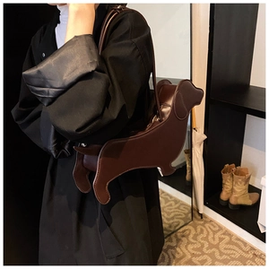 Side view of a creative dark brown leather dachshund dog shaped crossbody shoulder bag