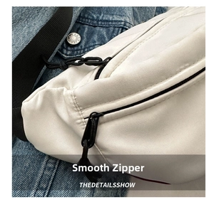 Detail of smooth double zippers on white oxford cloth crossbody bag with rope pulls