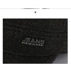 Detail of JEANS metal badge on thick winter wool cap with sandwich shaped peaked cap design