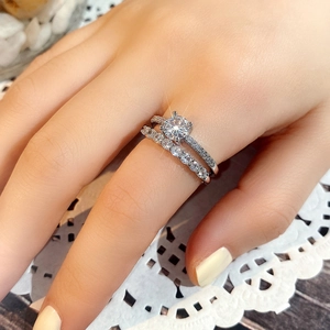 Close-up of minimalist silver rings set with AAA zircon and four-prong solitaire setting