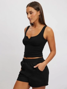 Close-up of black ribbed knit vest with buttoned U-neck and matching athletic shorts