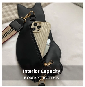 Detail showing the internal capacity of the cat-shaped crossbody bag with a smartphone