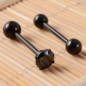 Macro shot of black stainless steel tongue rings with zircon stone and barbell design