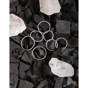 Set of seven minimalist S925 sterling silver 1mm thin twist rings on charcoal