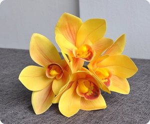 Close-up of artificial yellow cymbidium orchid with 3D printed texture for home decor