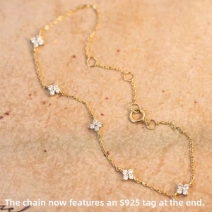 Detailed close-up of S925 sterling silver golden clover bracelet with zircon stones