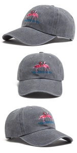 Close-up of pink flamingo embroidery on washed cotton vintage baseball cap in dark grey