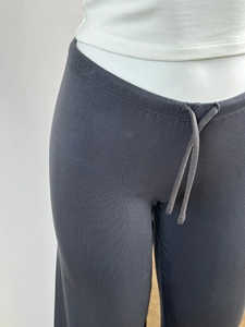 Detail of dark grey drawstring waist on summer wide leg trousers with soft fabric texture