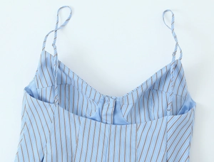 Détail d'un caraco à rayures bleues et blanches avec fines bretelles et décolleté en V