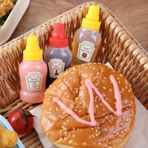 Mini portable squeeze bottles for salad dressing and soy sauce in a picnic basket