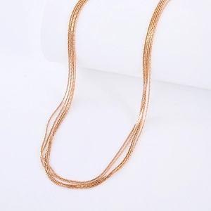 Elegant multi-layered rose gold stainless steel necklace on a clean white background