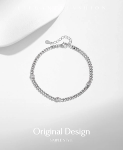 Macro shot of S925 sterling silver chain featuring bezel-set round sparkling moissanite stones