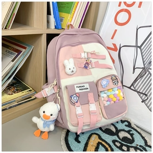 Pink and beige school backpack with cartoon badges, plush charms and multiple pockets