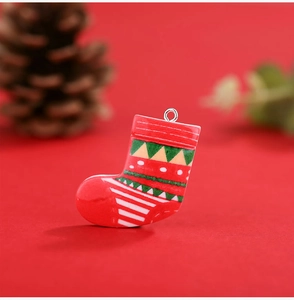 Macro view of a red resin Christmas stocking pendant with DIY hanging ring ornament