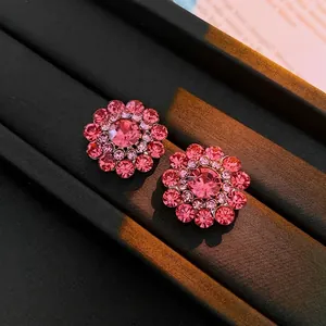 Elegant gold flower stud earrings with pink crystals and micro diamond inlay