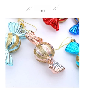 Detailed view of electroplated candy-shaped Christmas ornaments with glitter spiral stripes