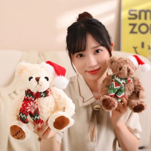 Cute teddy bears with Christmas hats and scarves, held by a model in a warm setting