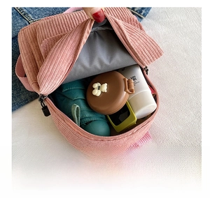 Detail showing the internal storage capacity of the pink corduroy mini backpack