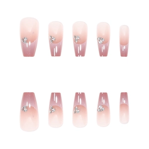 Pink gradient coffin press-on nails set with delicate rhinestone accents on white background