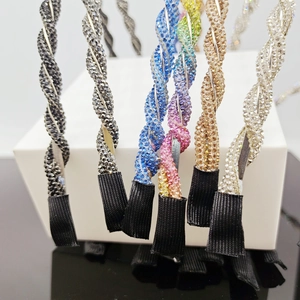 Close-up of twisted rhinestone headbands in multiple colors with sparkling crystal detail